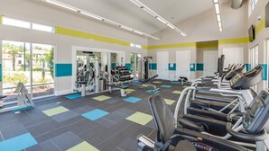 A gym with treadmills, weight machines, and a mirrored wall. - Exclusive 5 Star Mansion on Veranda Palms Resort, Orlando Mansion 5670 (Kissimmee)