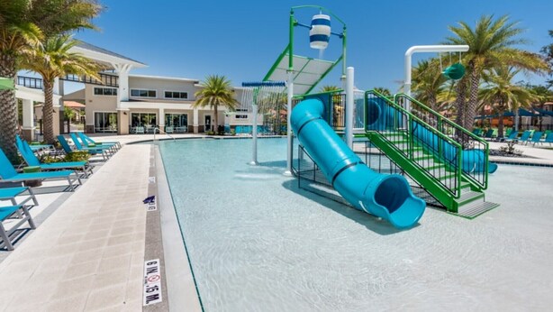 A swimming pool with a blue slide and a water play area. - Exclusive 5 Star Mansion on Veranda Palms Resort, Orlando Mansion 5670 (Kissimmee)