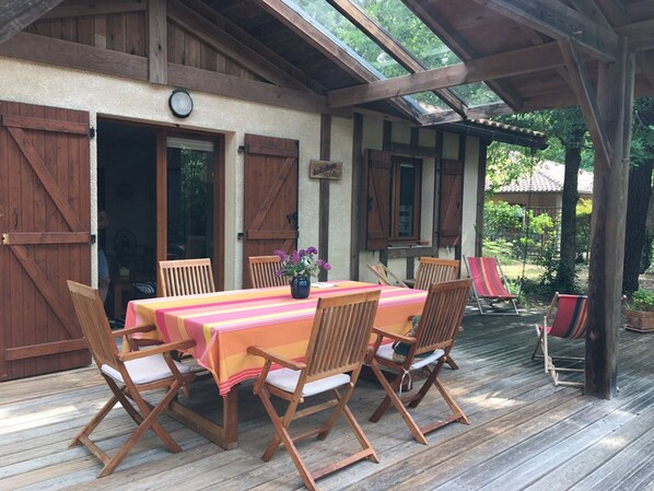 Enjoy al fresco dining in this charming outdoor space with a table for six and comfortable seating.