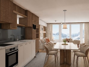 Una cocina moderna con electrodomésticos integrados, un comedor con una mesa grande y sillas, y vistas a montañas desde las ventanas.