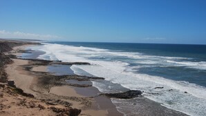 A coastal beach with a clear sky. - Charming villa facing the sea. (province chtouka Ait Baha)