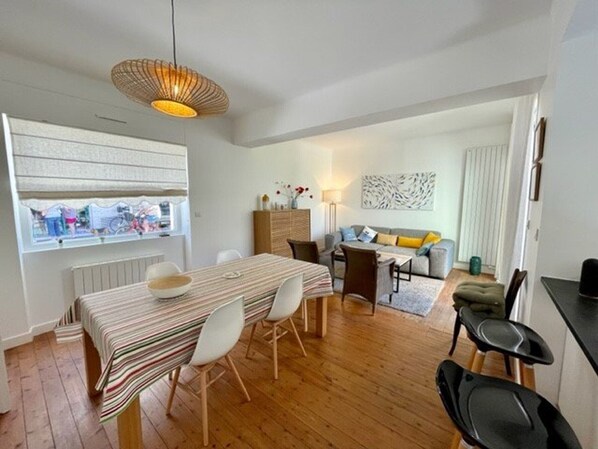 Relax in this stylish living space with a dining area, sofa, and city view.
