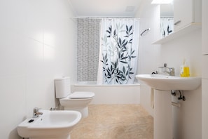 Bathtub, hair dryer, towels