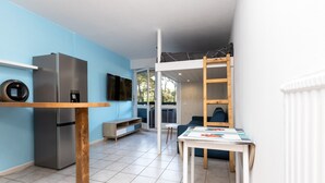 A modern kitchen with a built-in refrigerator, a wooden table, and a ladder. - Studio Seignosse near the "Le Penon" beach (1 min) with balcony (Seignosse)
