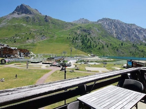 A mountain view with a restaurant and a ski lift in the foreground.