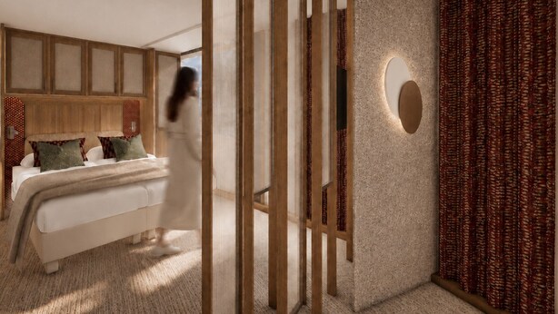 A modern bedroom with a bed, a wooden partition, a wall-mounted light, and patterned curtains.