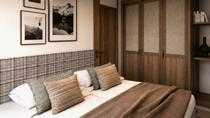 A bedroom with a bed, a wardrobe, and three framed pictures on the wall.