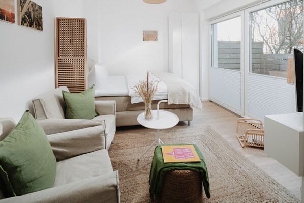A modern living room with a sofa, a coffee table, and a small rug.
