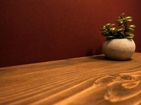A wooden table with a potted plant.