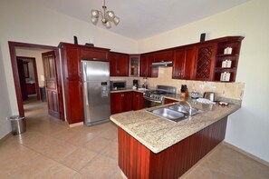 Fridge, cookware/dishes/utensils, dining tables