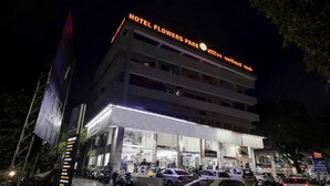 A multi-story building with a sign reading "HOTEL FLOWERS PARK" at the top. - Itsy Hotels Flowers Park (Nashik)