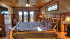 A wooden bedroom with a bed, dresser, and nightstands.