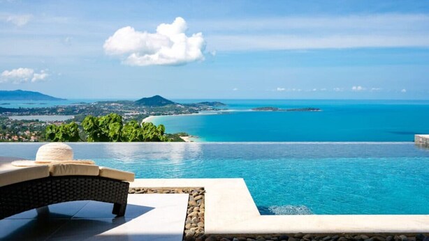 A infinity pool with a view of a coastal landscape, including a beach and distant mountains. - `Villa Majesta`Amazing View, luxury 4br Pool villa (Koh Samui)
