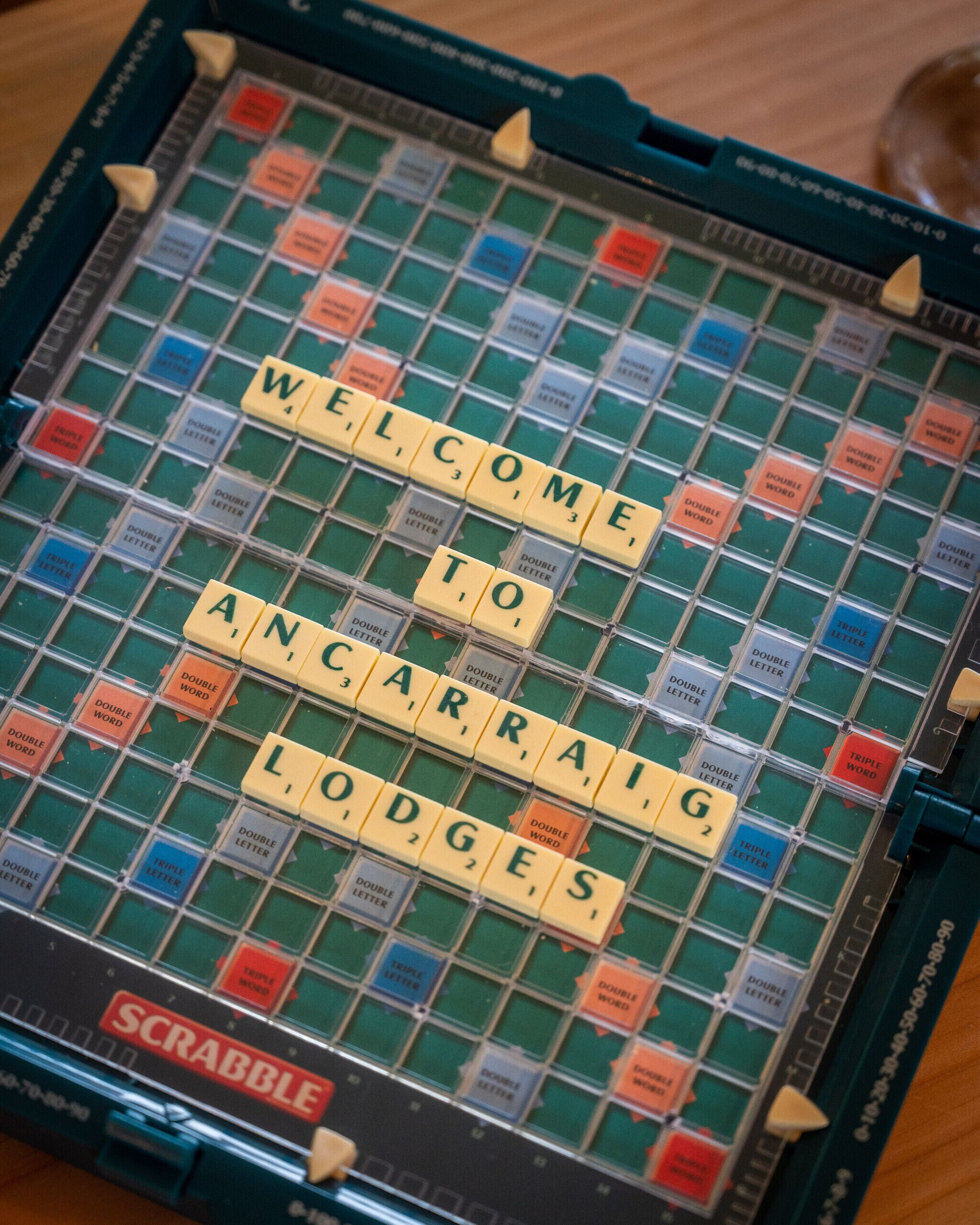 A Scrabble board with the word "WELCOME TO ANCARRAIG LODGES" spelled out.