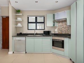 Design Apartment | Private kitchen | Full-size fridge, microwave, oven, stovetop