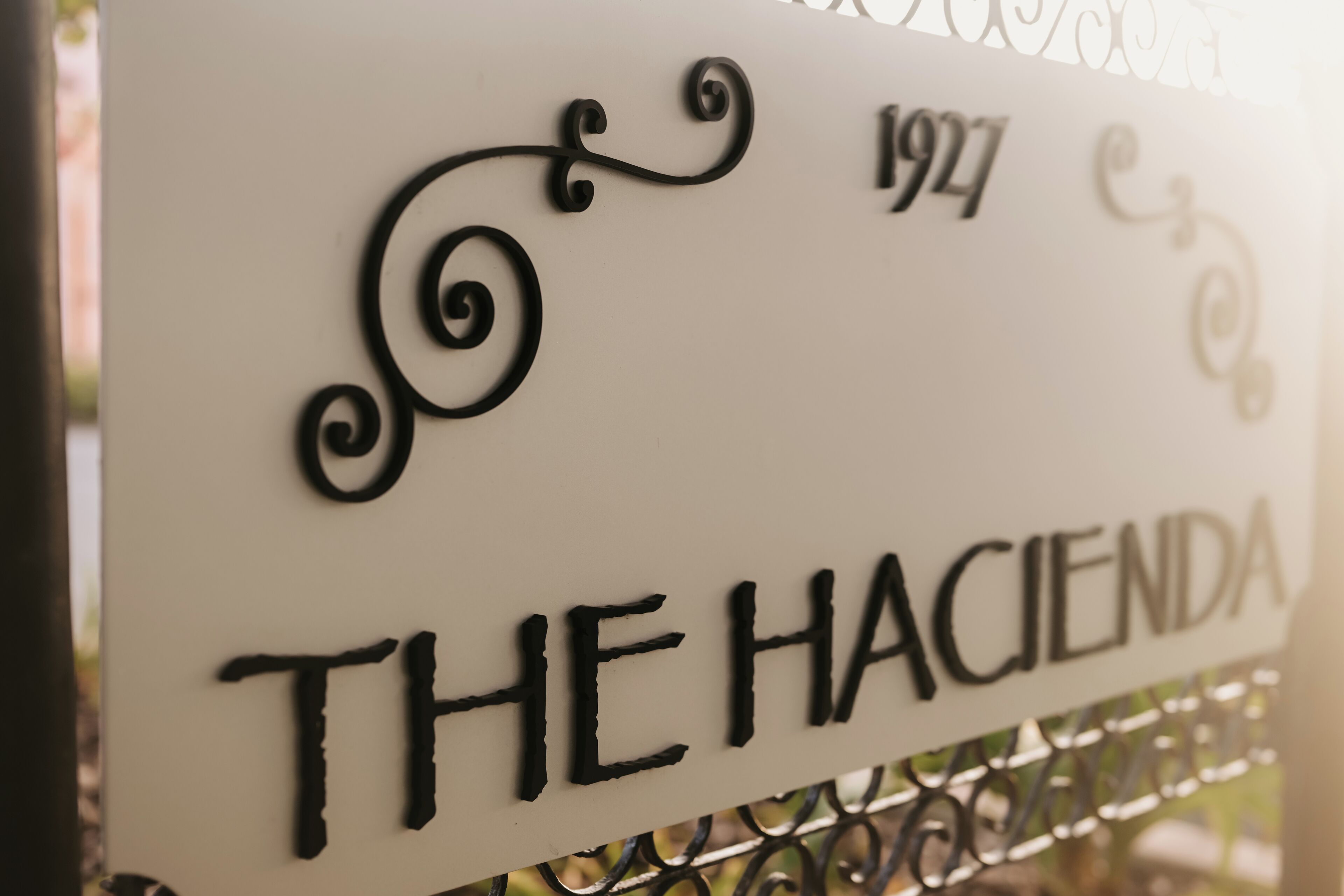 A sign with the text "THE HACIENDA" and the year "1927".