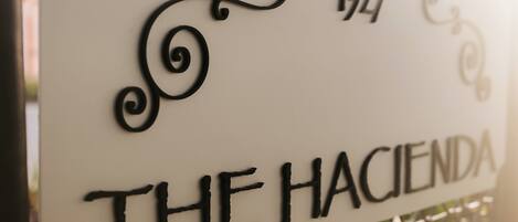 A sign with the text "THE HACIENDA" and the year "1927".