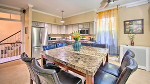 A modern kitchen with a dining area, including a granite table, chairs, and a ceiling fan. - 1 Mi to Dtwn: Historic Harrisburg Home (Harrisburg)