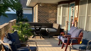 A wooden deck with outdoor furniture including lounge chairs and a sofa. - Family suite sleeps 11!  We are near Champaign-Urbana 4 bedrooms & 2.5 bathrooms (Saint Joseph)