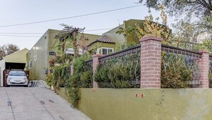 A residential property with a garage, a brick wall, and a metal gate.