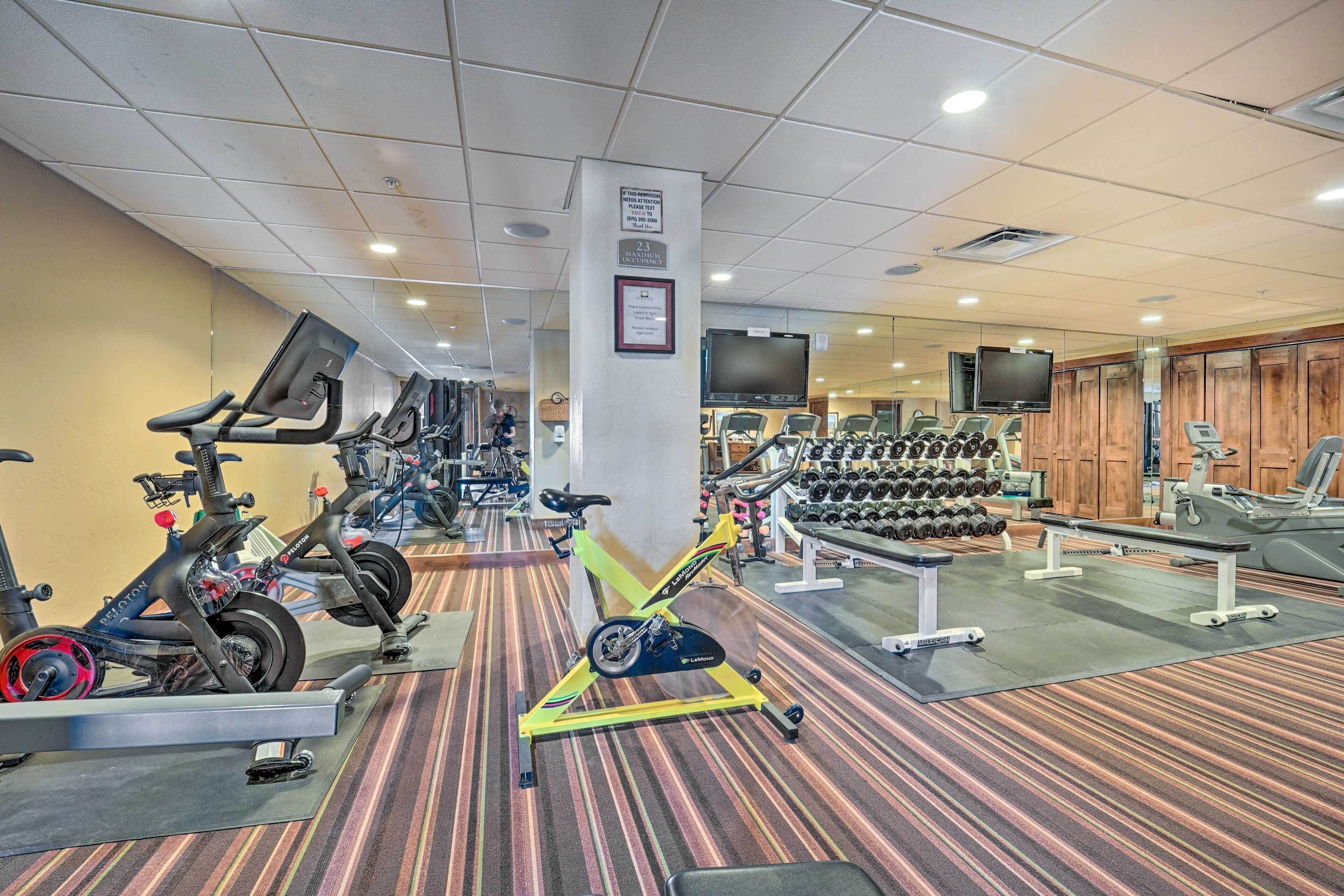 A gym with stationary bikes, treadmills, and weight machines.