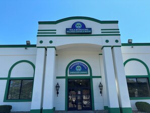 A building with a sign reading "Tesla Biohealing Wellness Center & Resort" and "Energyized Fitness Energized Dining" at the entrance.