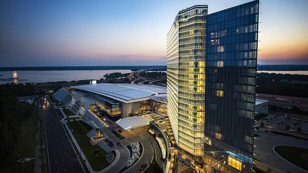 A modern hotel with a curved glass facade, a spacious lobby, and a view of the surrounding area. - Close to DC excellent location (Temple Hills)