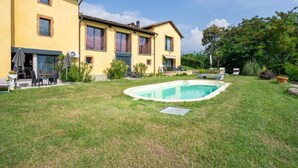 A two-story yellow house with a swimming pool in the backyard. - Parco Vira Apartments (Porza)