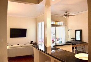 Relax in this stylish living room with a flat-screen TV, comfortable sofa, and coffee table.