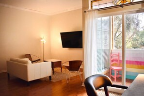 Relax in a cozy space with a flat-screen TV, comfortable sofa, and dining area.
