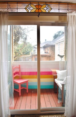 Enjoy a view of the surrounding neighborhood from the comfort of this room, featuring a glass door leading to an outdoor area.