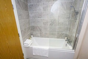 Shower, hair dryer, towels, shampoo