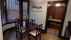 A dining area with a wooden table and chairs, a chandelier, and a painting on the wall. - Classic Build with modern decor (Chattanooga)