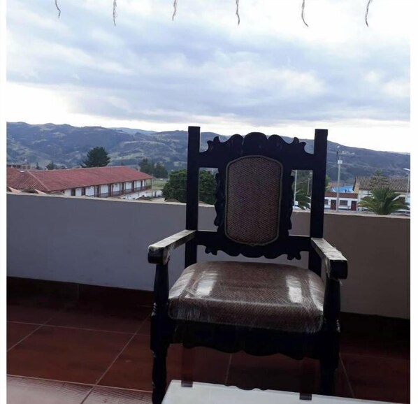 Sit comfortably on the balcony with a chair and take in the views of the surrounding houses and mountains.