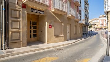 A building with a 'limehome' sign, a '2A' room number, and a red 'AT' sign on the door.