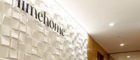A hallway with a textured wall and the word "limhome" visible.