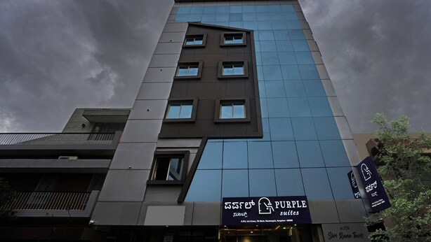 A modern building with a sign for 'Purple Suites' on the ground floor. - Itsy Hotels Purple Suites (Bengaluru)
