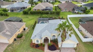 A residential area with houses featuring sloped roofs, some with solar panels, and well-maintained lawns. - Luxurious Relaxing Retreat (Davenport)