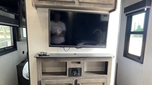 A compact kitchen with a built-in TV, a microwave, and a small cabinet. -  Comfortable & Private Stay in Moreno Valley (Moreno Valley)