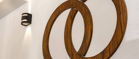 Two wooden rings mounted on a white wall.