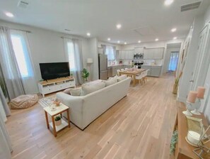 Relax in this cozy living area with a sofa set, television, and dining table.