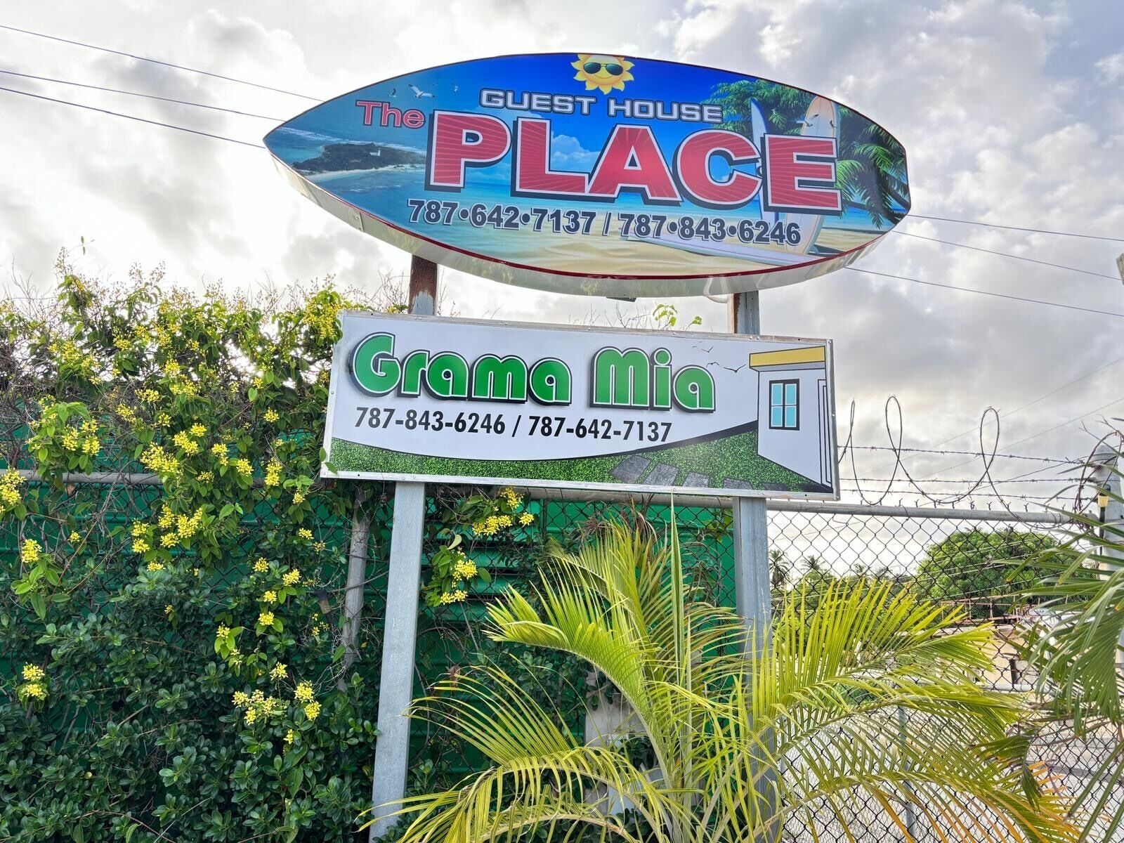 A sign for 'The Guest House Place' with contact numbers.