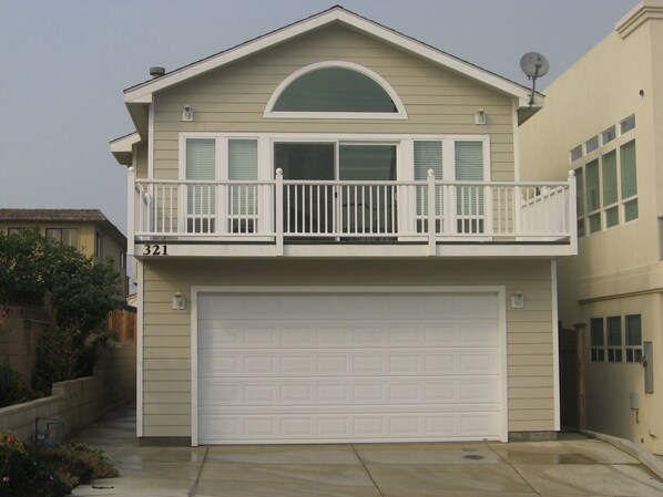 A two-story house with a garage, a balcony, and a satellite dish. - Seaside! Steps to sand & minutes to dunes! (Oceano)