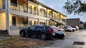 A multi-story motel with a parking lot. - Pharr Executive Inn (Pharr)
