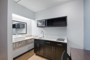 Full-sized fridge, microwave, stovetop, dining tables
