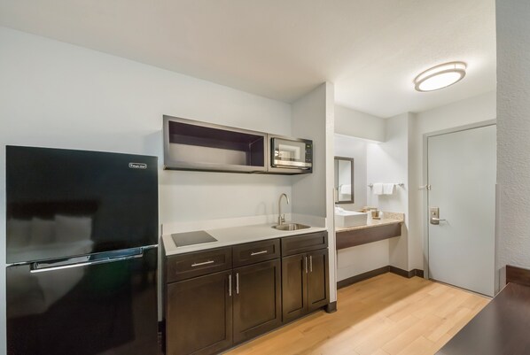 Full-size fridge, microwave, stovetop, dining tables