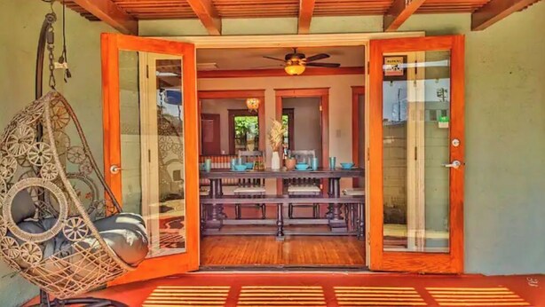 A room with a wooden ceiling, a ceiling fan, a hanging chair, and a dining area with a table and chairs. - Craftsman 4 Bed/2 Ba. Home Sleeps 10, AC & Parking (Long Beach)