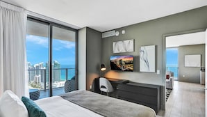 A modern hotel room with a large bed, a desk, and a view of the cityscape. - 2BR Oceanview HYDE – Free Parking, No Resort Fee (Hollywood)