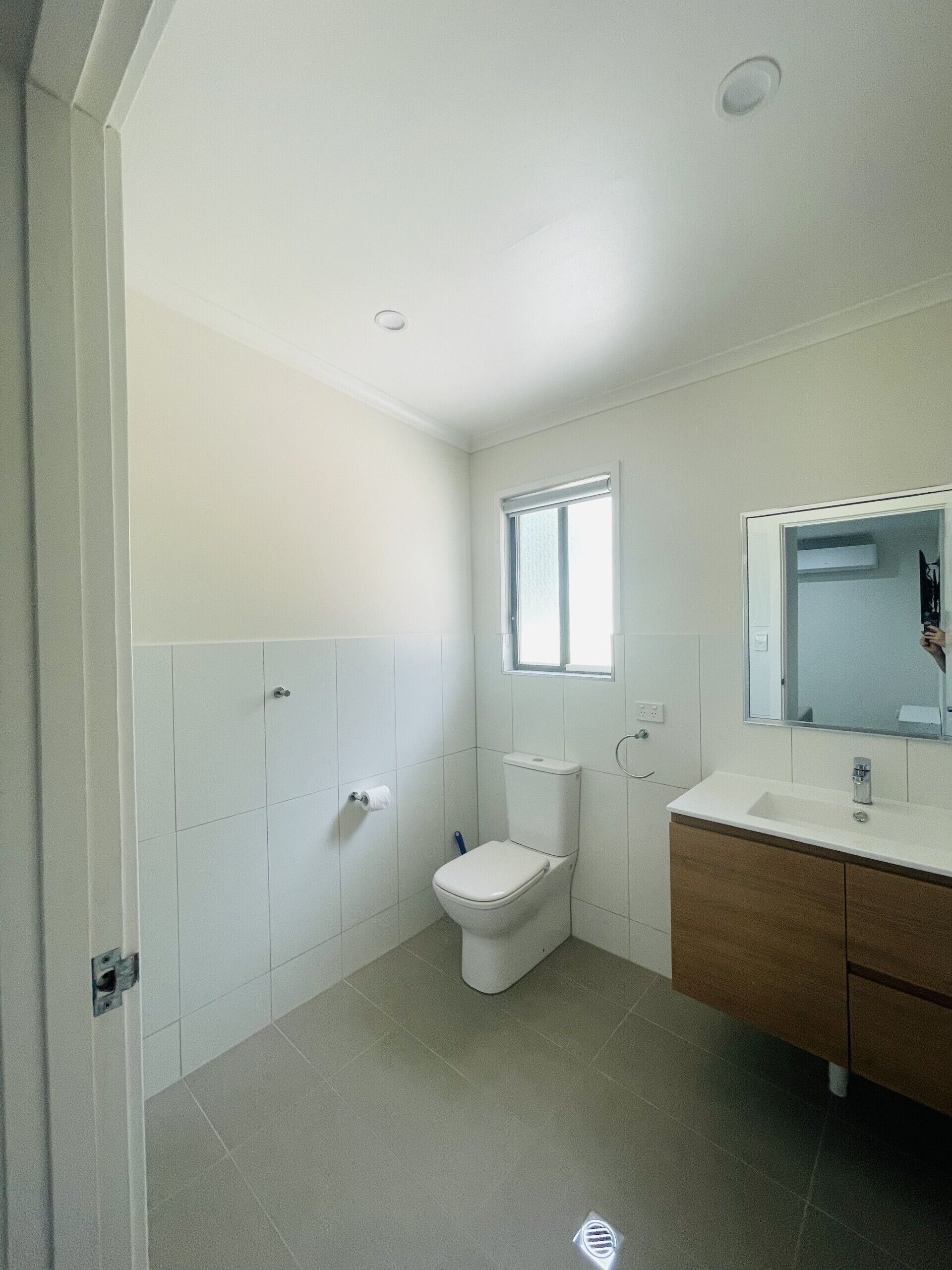 Un baño con inodoro, lavamanos y ventana.