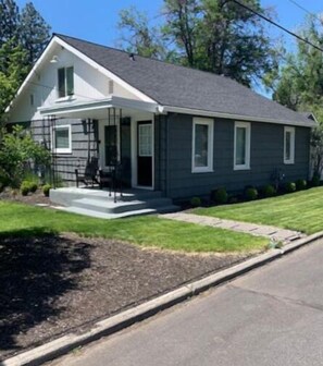 A single-story house with a front porch, a small front yard, and a driveway. - Walk to downtown and the river! (Bend)